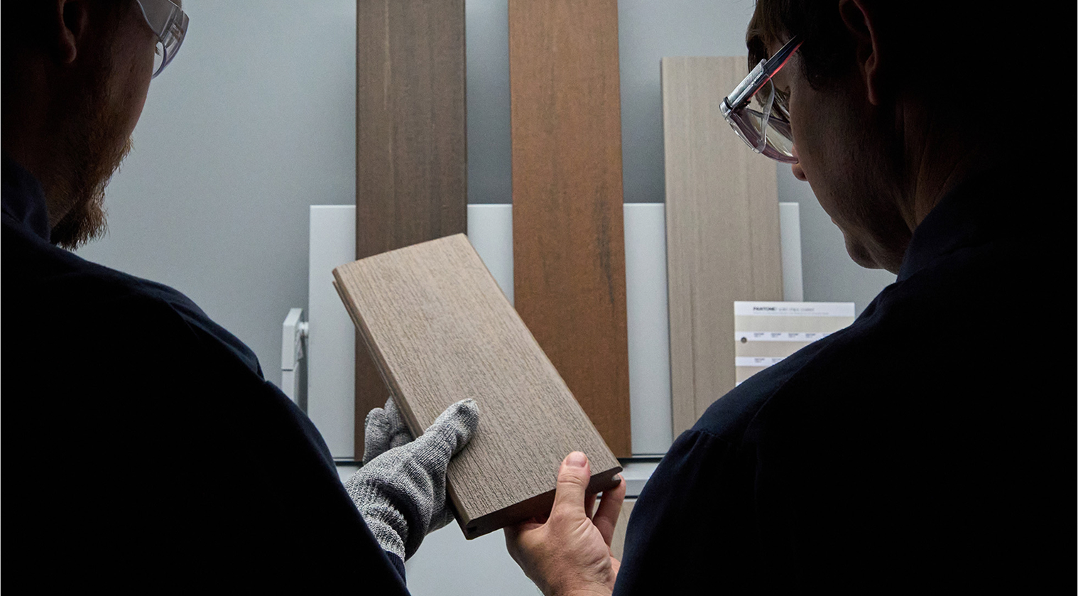 Technicians looking at a TimberTech deck board sample
